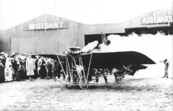 Santos Dumont Demoiselle in front of hangar row, 1910