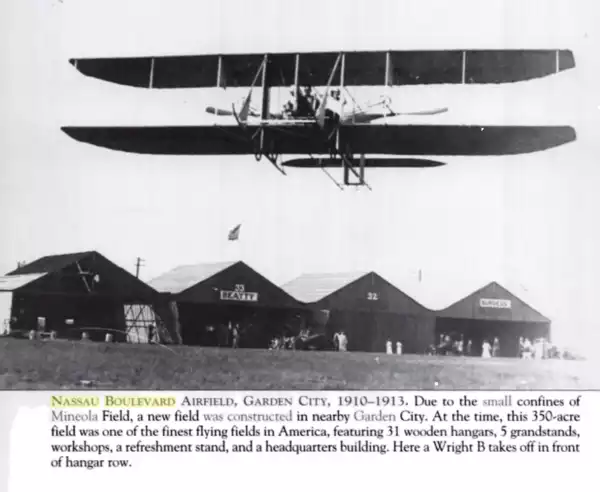 Wright B takes off in front of hangar row