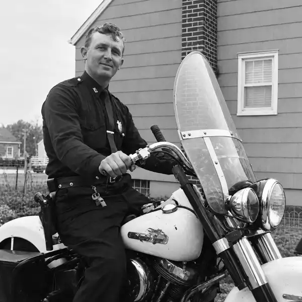 Puts on police motorcycle